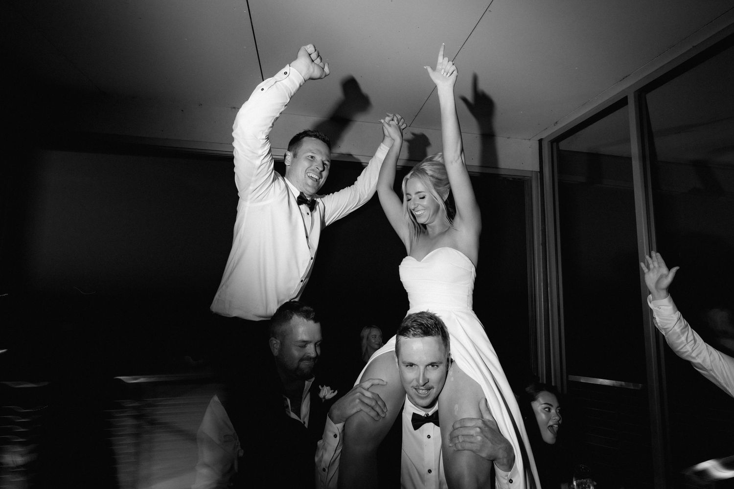 Black and white photo of energetic wedding reception dancing and celebration.