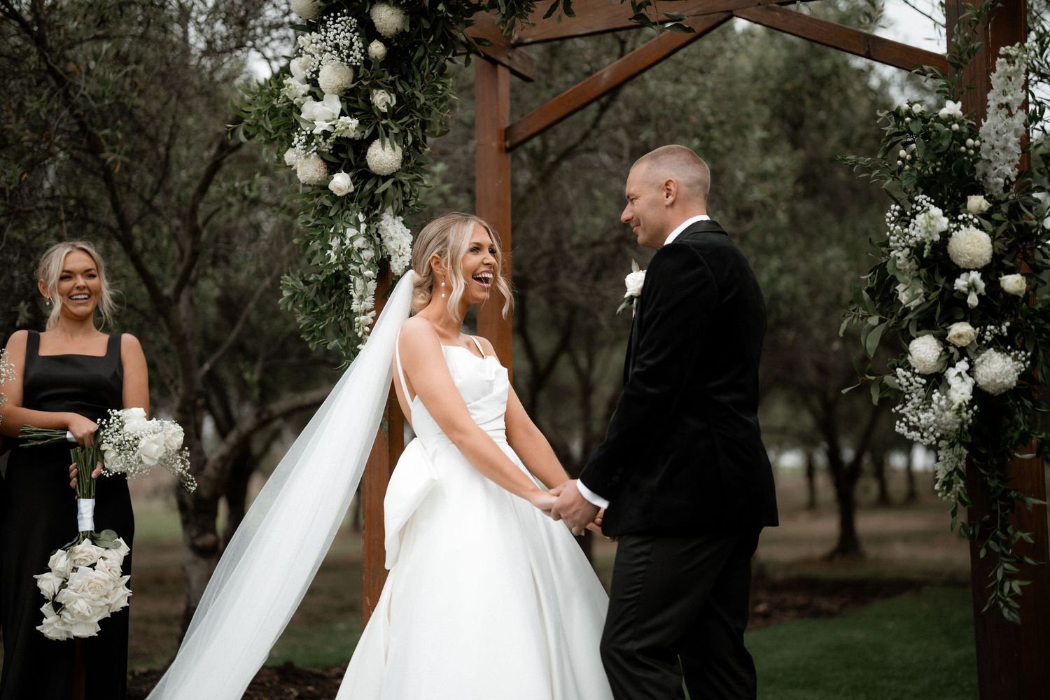 Sequence of outdoor wedding photographs showing moments between newlyweds in a garden setting with white floral decor.