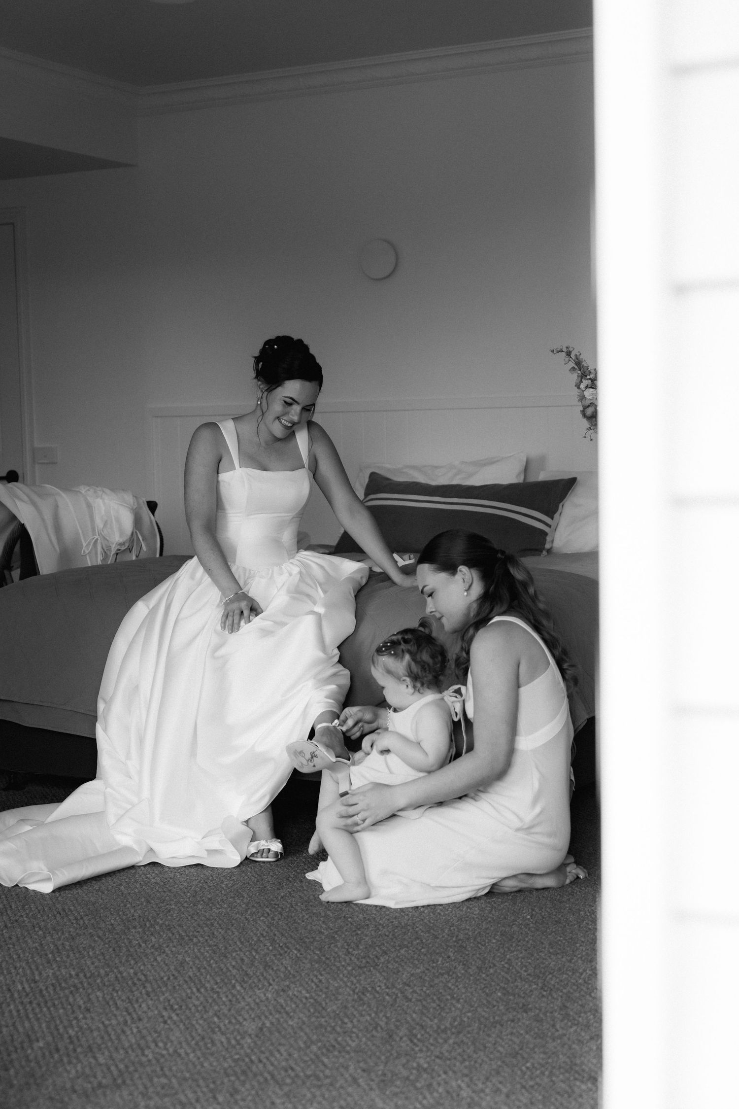 A sequence of black and white photos showing people resting on carpeted floor in formal white attire.