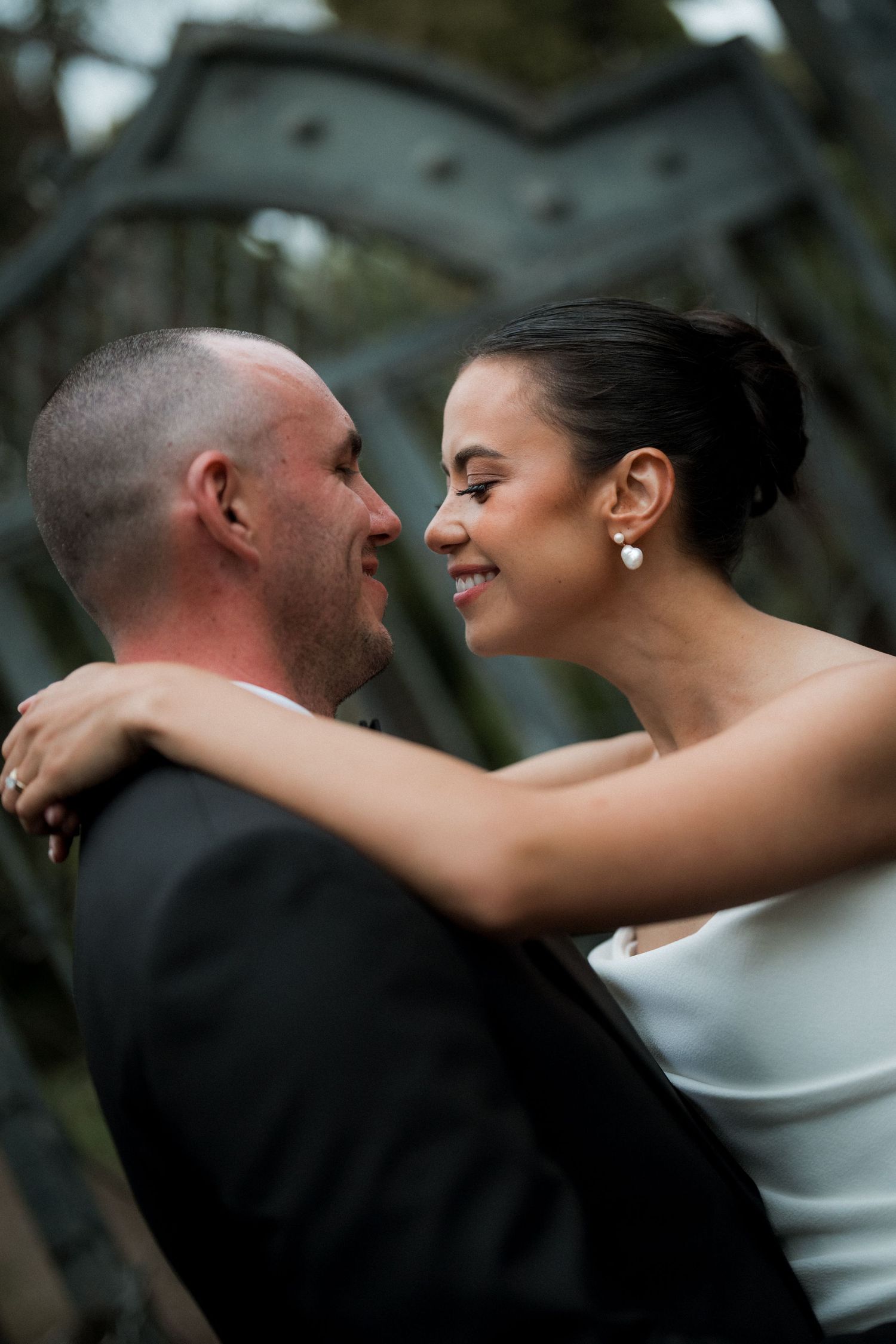 Intimate wedding couple moment captured in romantic outdoor portrait sequence.