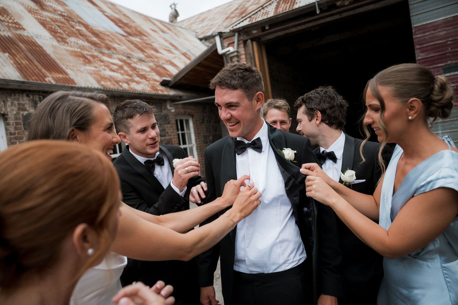 Wedding guests dance and celebrate together on the dance floor at a reception.