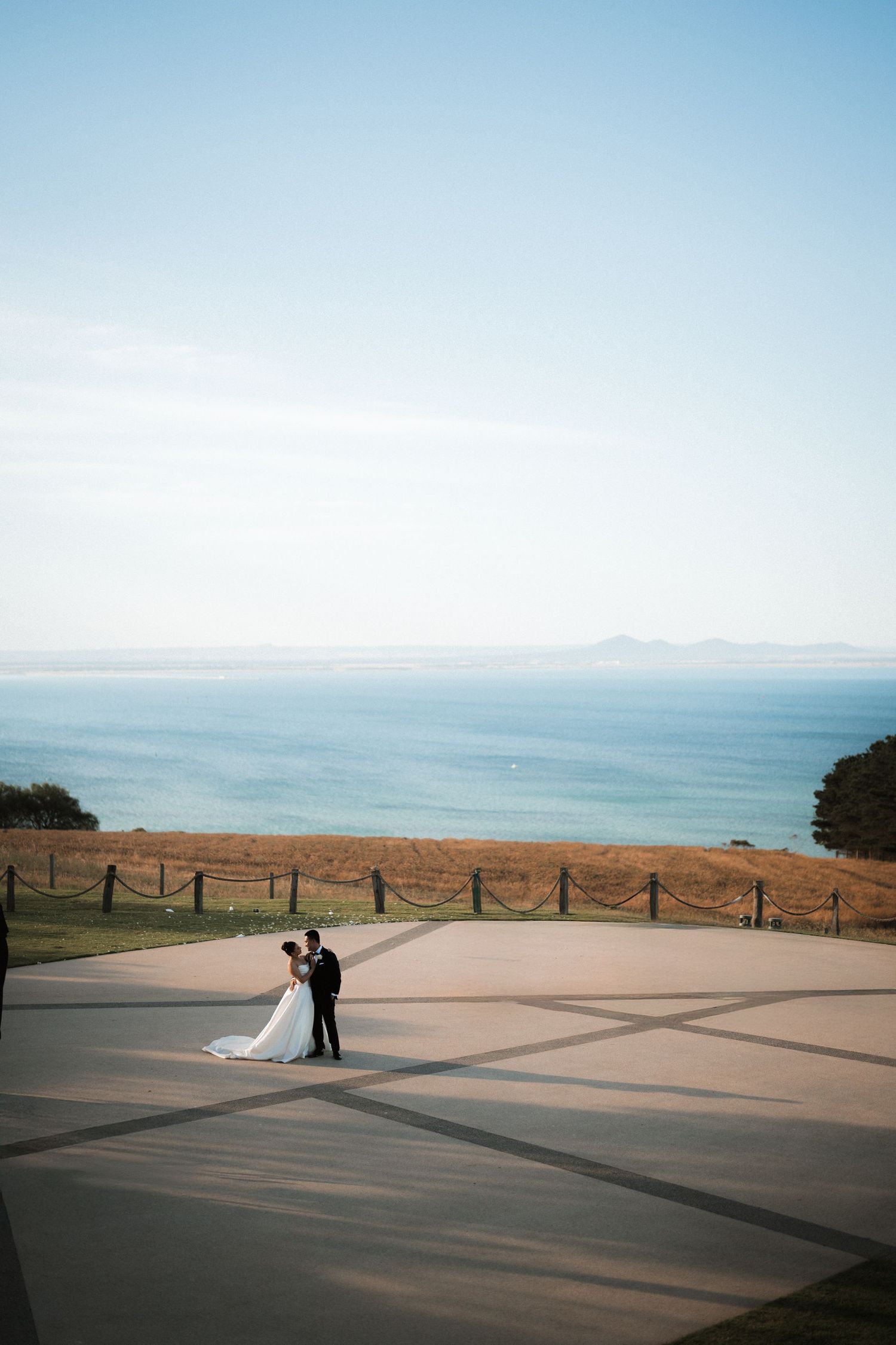 Coastal wedding photography with dramatic wide angles of a scenic oceanfront terrace.