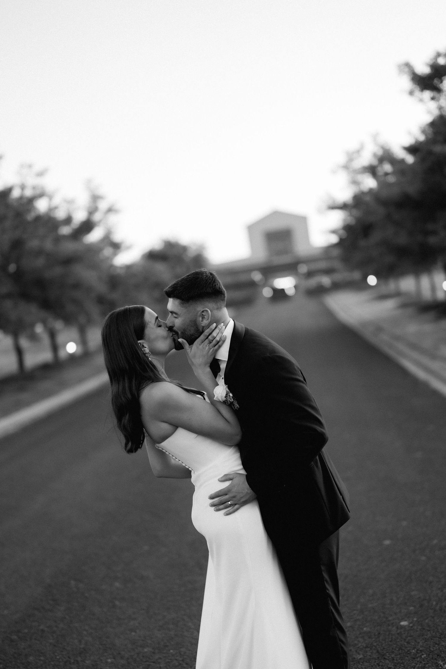 A romantic black and white wedding photo sequence showing a couple sharing an intimate moment on a path.