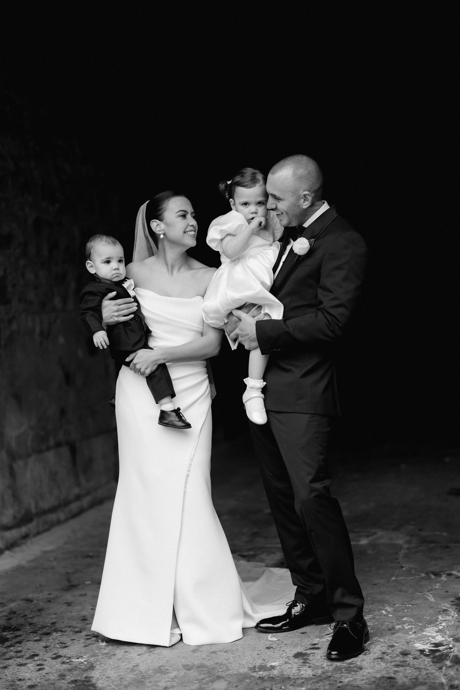 Playful black and white sequence of newlyweds dancing and embracing in formal attire.