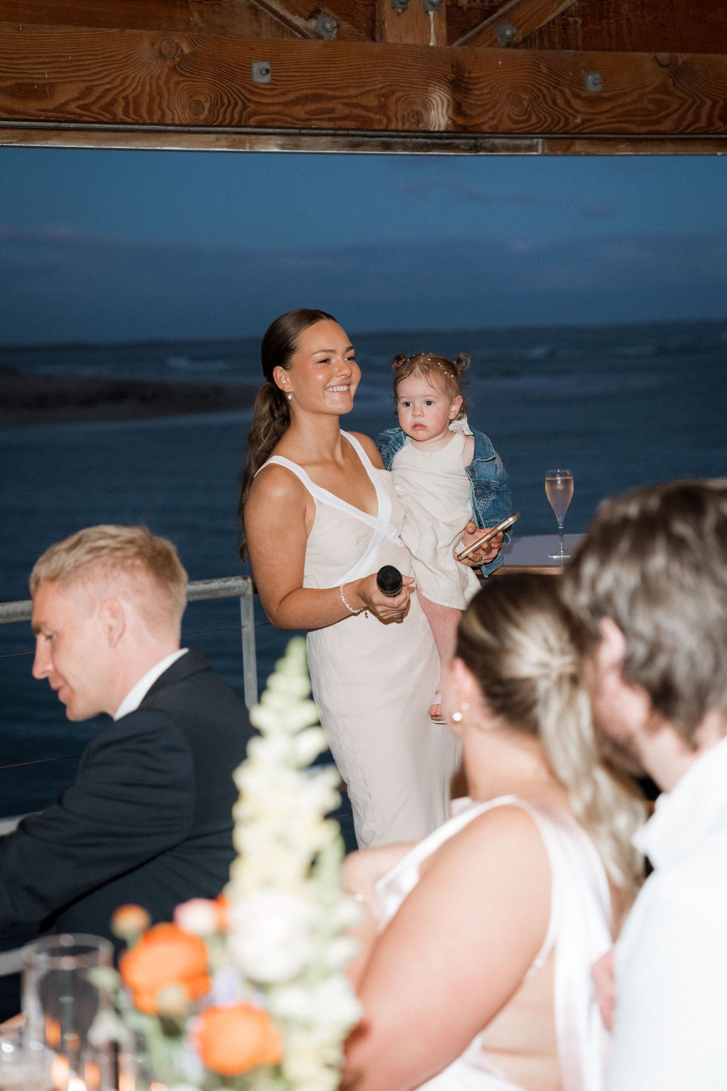 Wedding reception celebration at an oceanside venue with guests enjoying the festivities.