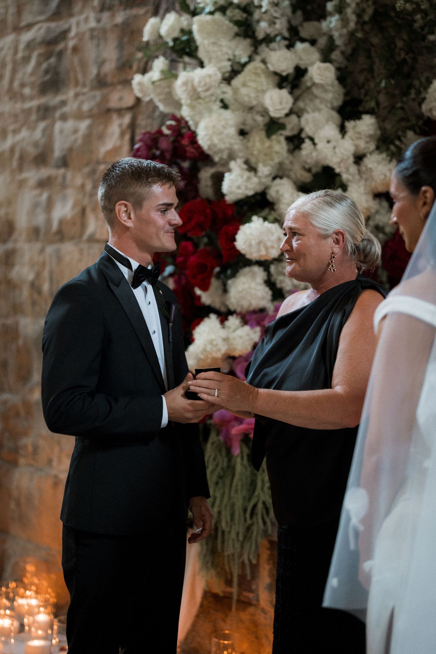 A sequence of wedding ceremony photos showing a couple exchanging rings in front of floral decorations.