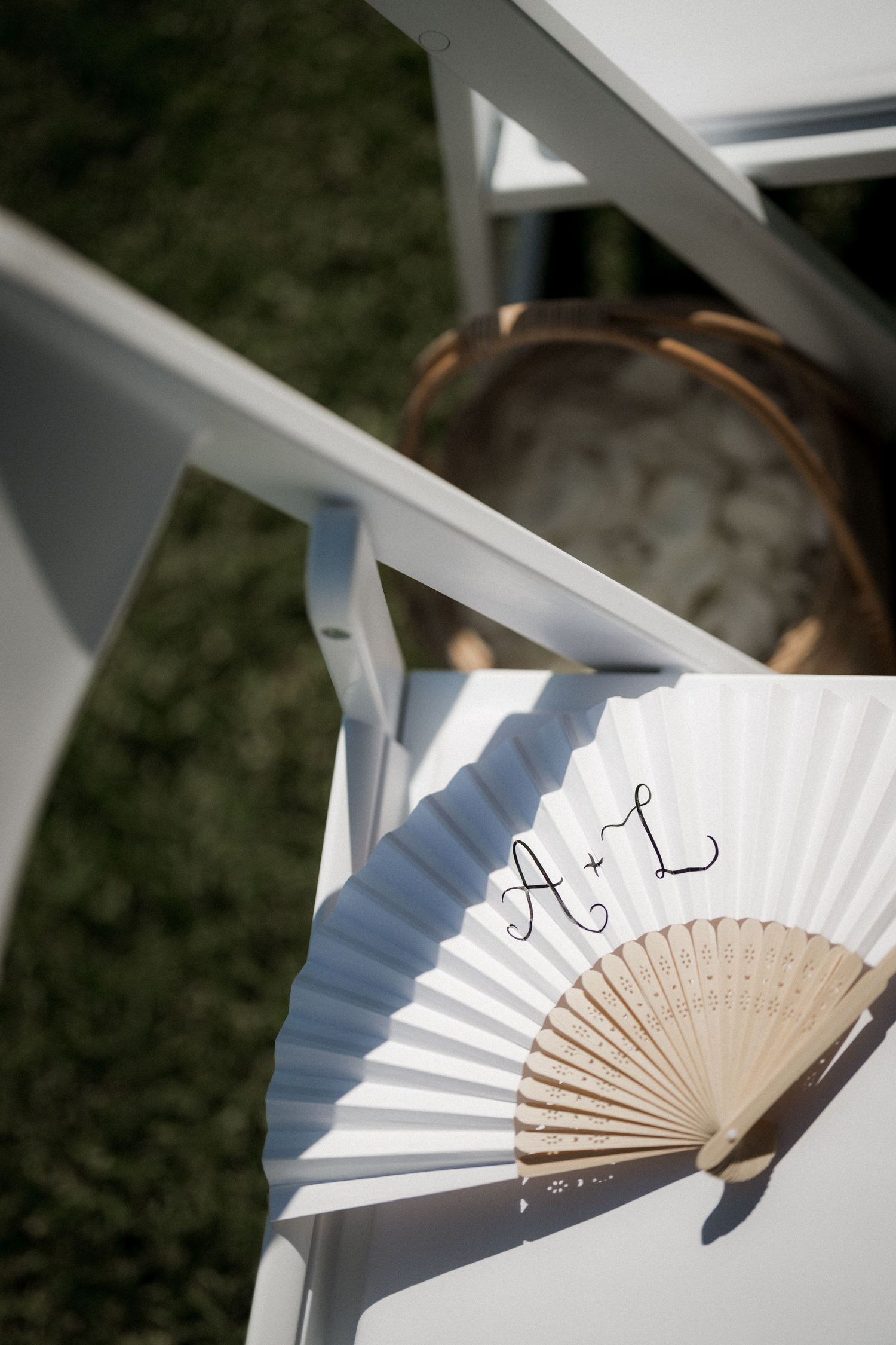Decorative white hand fan casting dramatic shadows against a light background in a series of artistic shots.