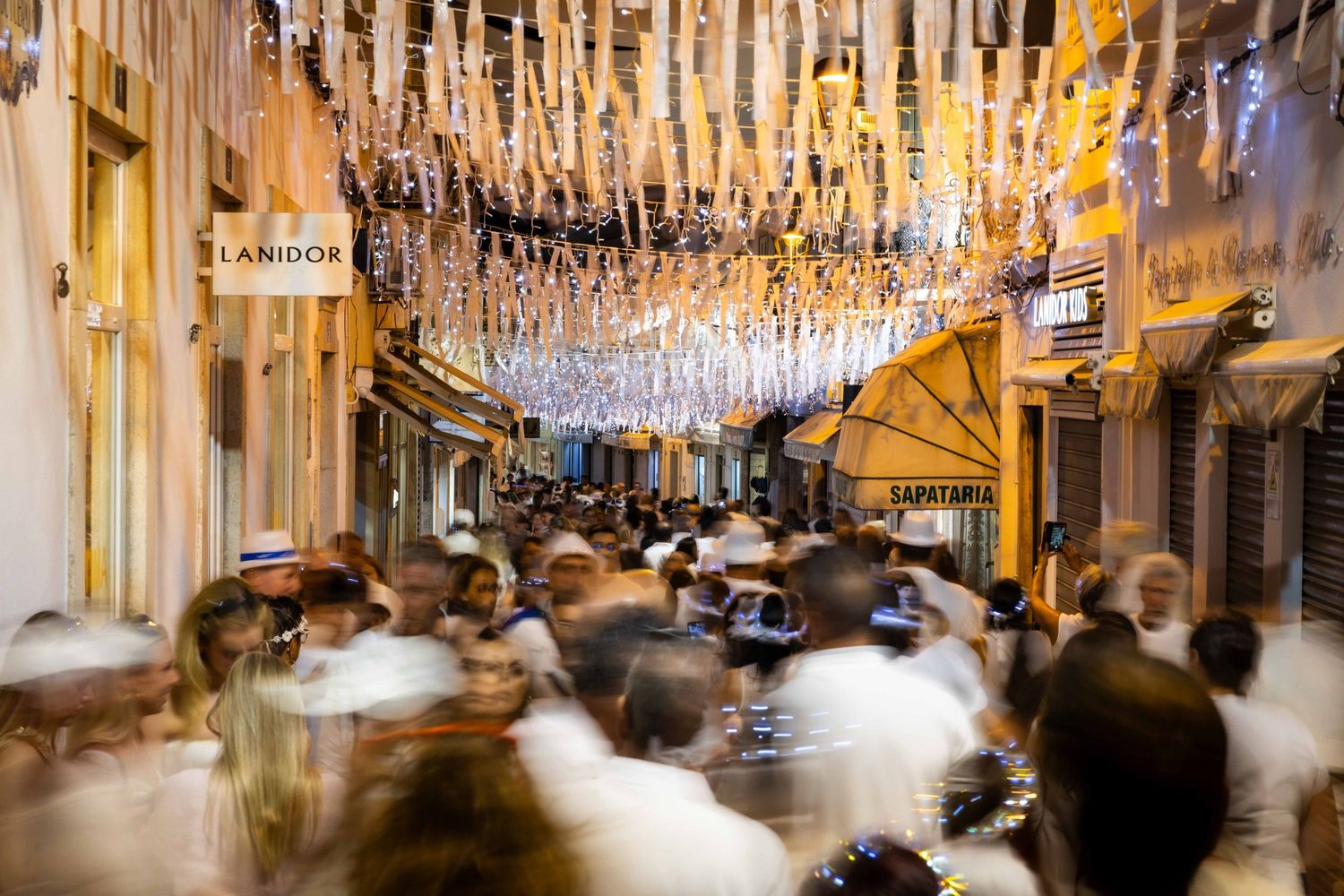 Crowds filling the streets during White Night festival in Loulé, Algarve, event photography by Anthony West