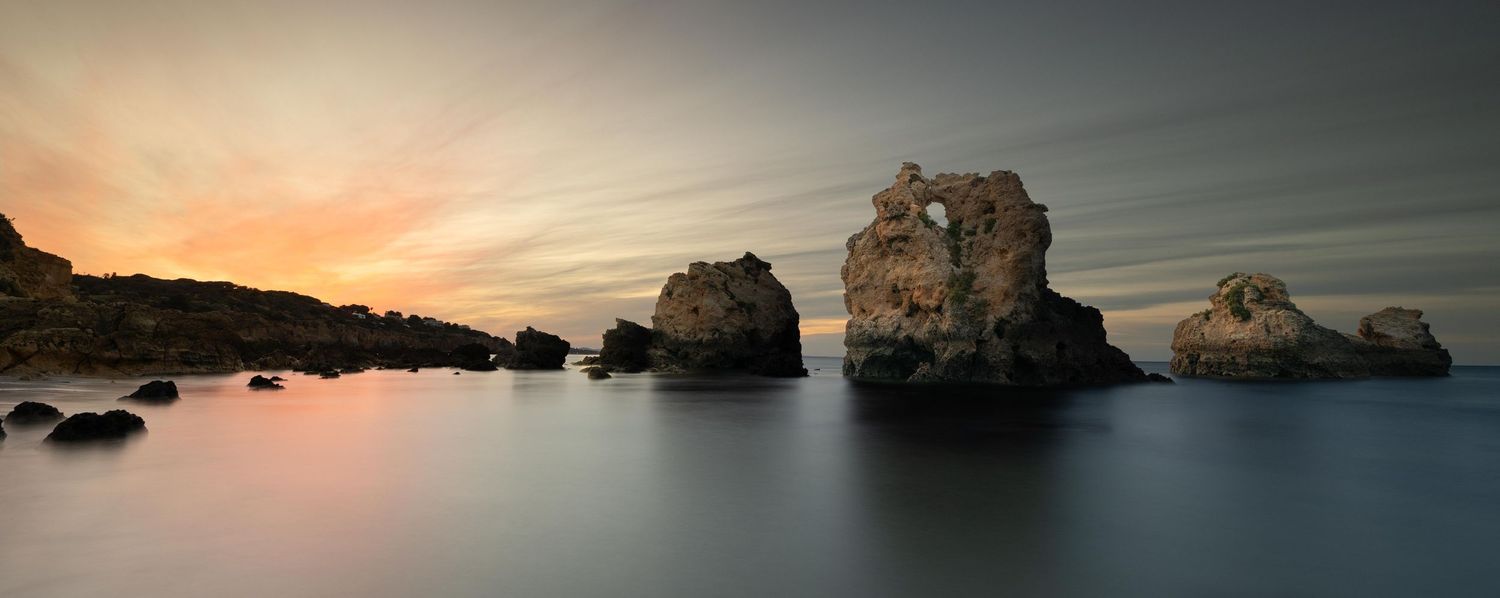 Long exposure sunrise over the rocky sea stacks at Praia de Arrifes, Algarve, fine art landscape photography Portugal