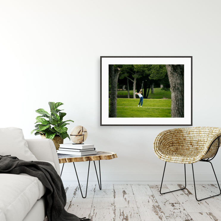 Framed golf action portrait print displayed on a living room wall, bespoke golf photography print by Anthony West