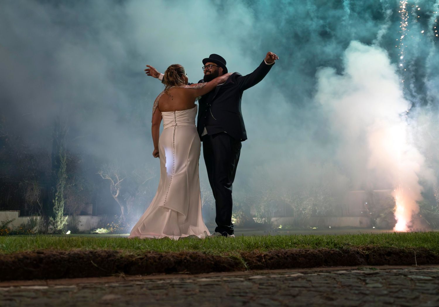 Bride and groom celebrating against a spectacular fireworks display at a wedding in Naples, Italy, wedding photography