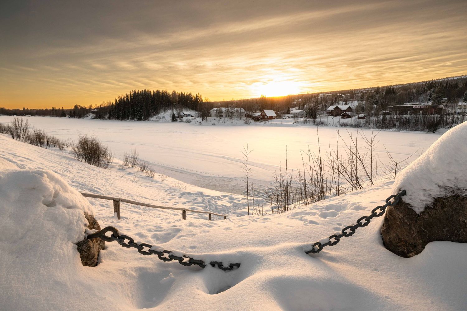 Golden sunset over a frozen river in winter, fine art landscape photography from Norway by Anthony West