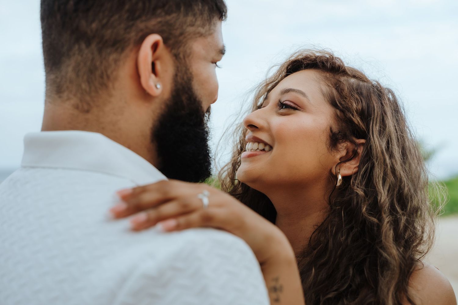 A romantic couple embraces and shares tender moments together in a series of intimate outdoor portraits.