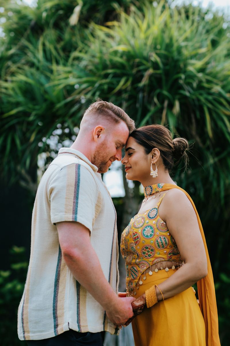 Intimate couple's portrait showing tender moments between two people in coordinated yellow and white outfits.