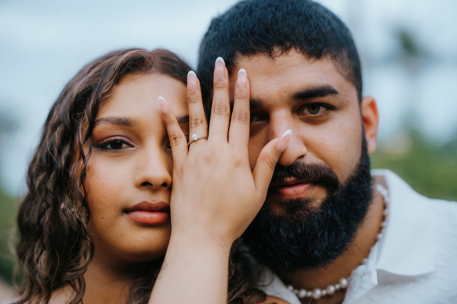 A couple poses playfully in a series of romantic outdoor engagement photos.