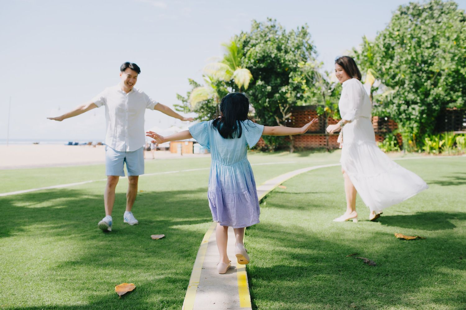Carefree moments captured in a scenic grassy field near the ocean.