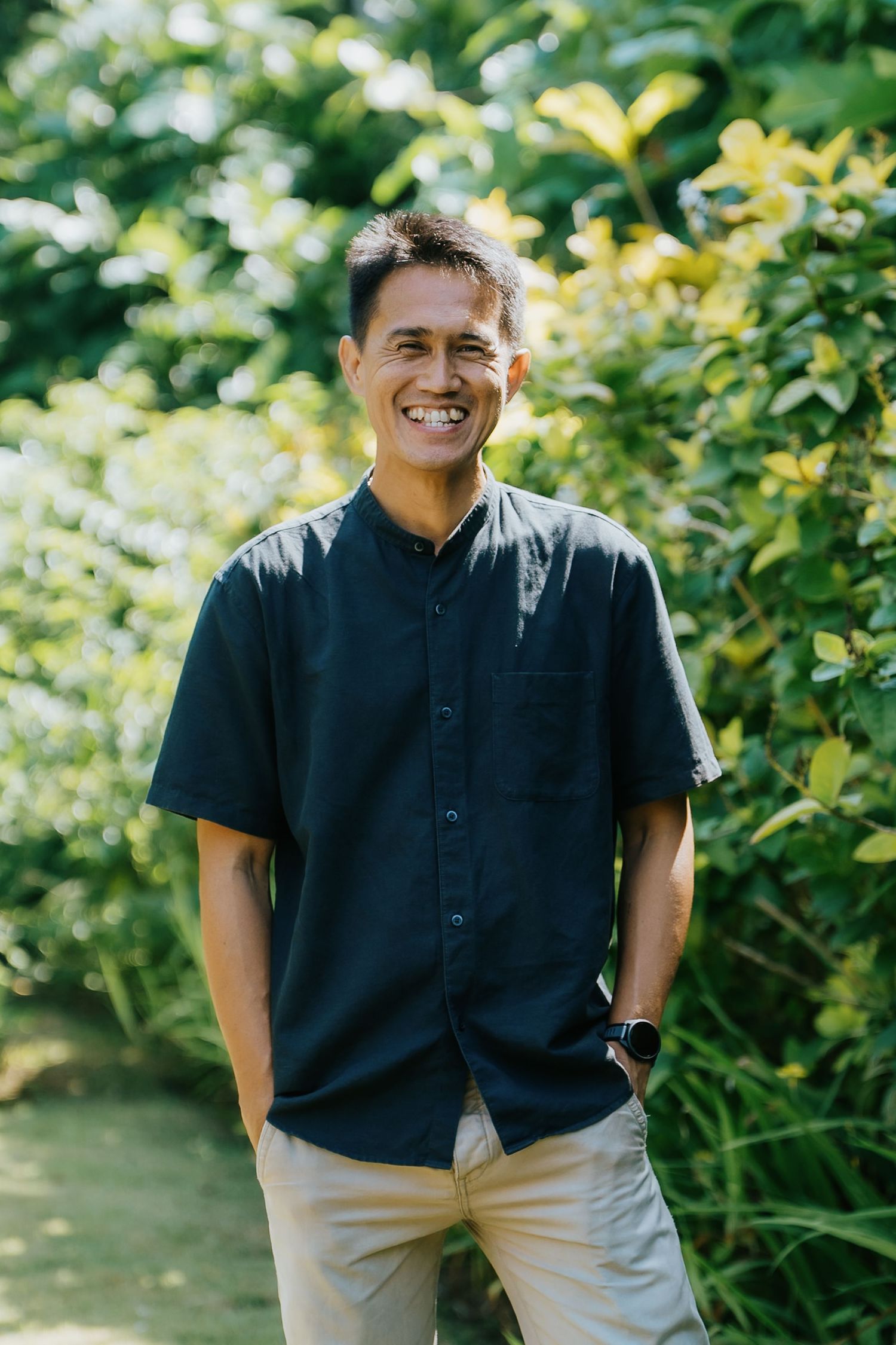 Portrait series in a garden setting with natural lighting and leafy green backdrop.