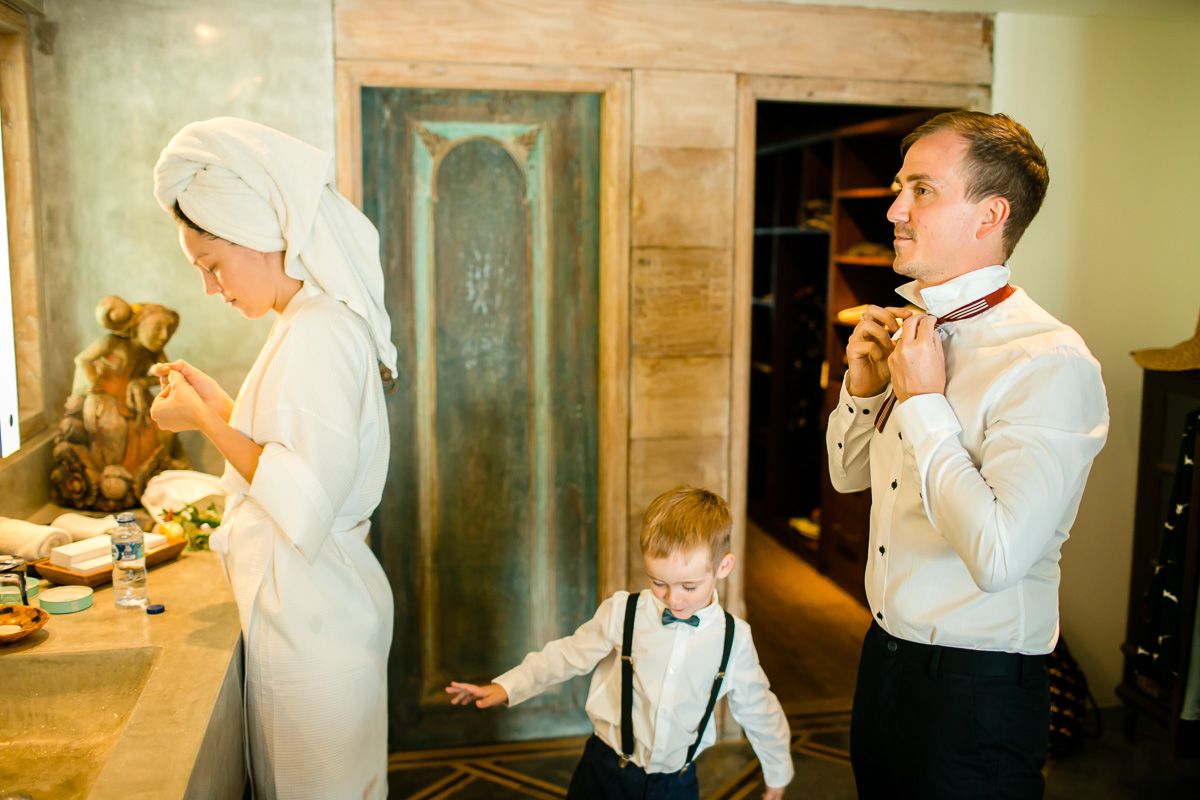 Wedding preparation scene in a rustic room with warm lighting.