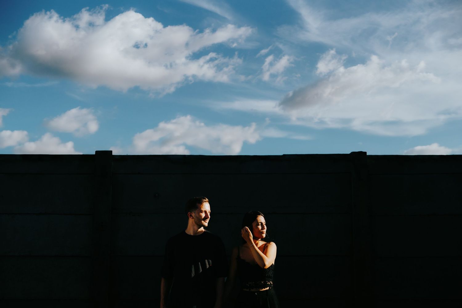 Dramatic skyline silhouettes against blue clouds during golden hour.