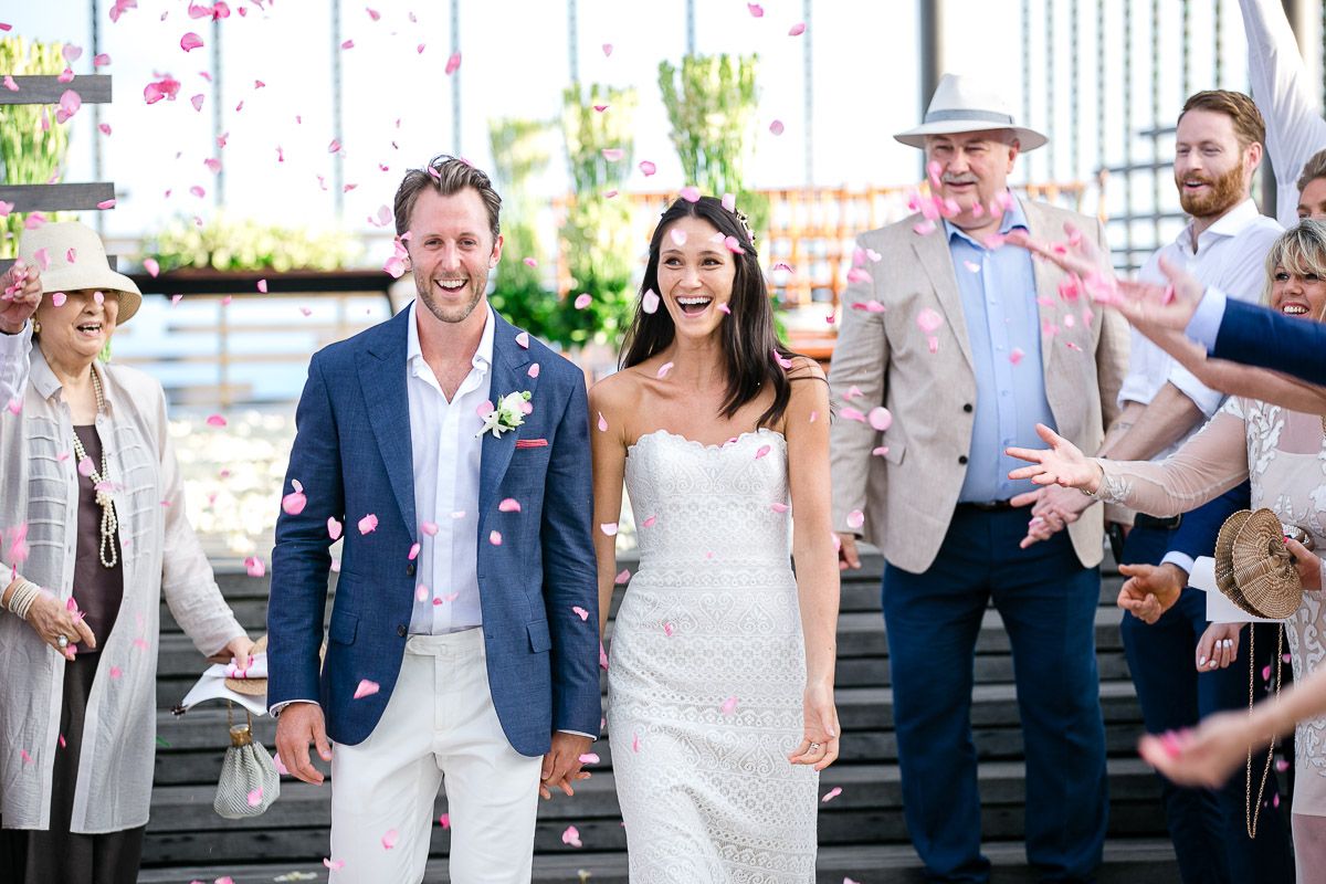 Wedding party celebrates during a joyful outdoor reception with festive decorations and lighting.