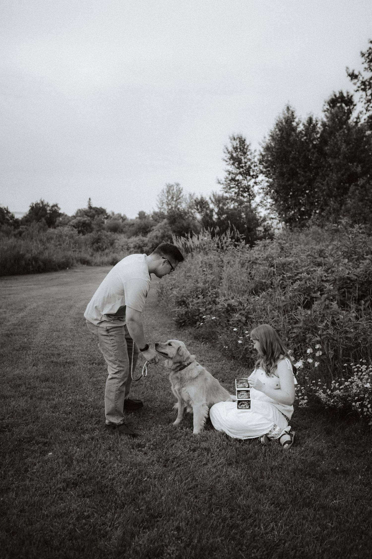 A series of vintage black and white photos showing two people interacting in a grassy outdoor setting.