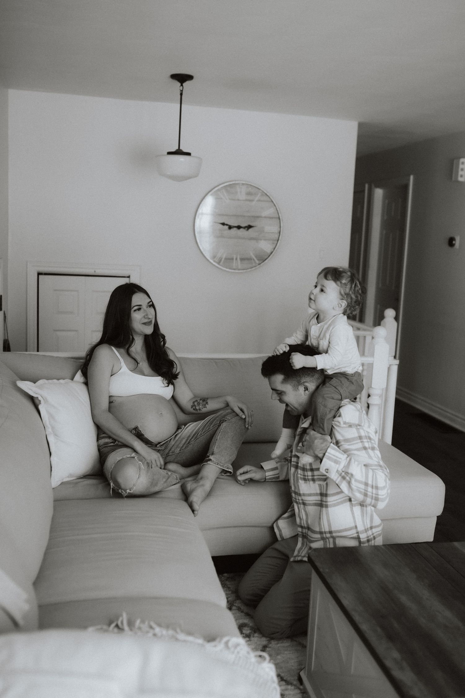 A sequence of photos showing two people lounging together on a light colored couch in a modern minimalist living room.