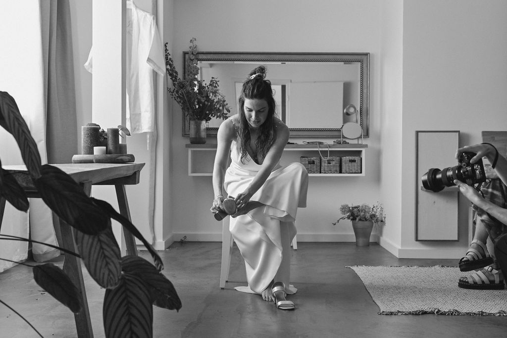 A black and white photo sequence shows a person performing graceful dance movements in an empty room.