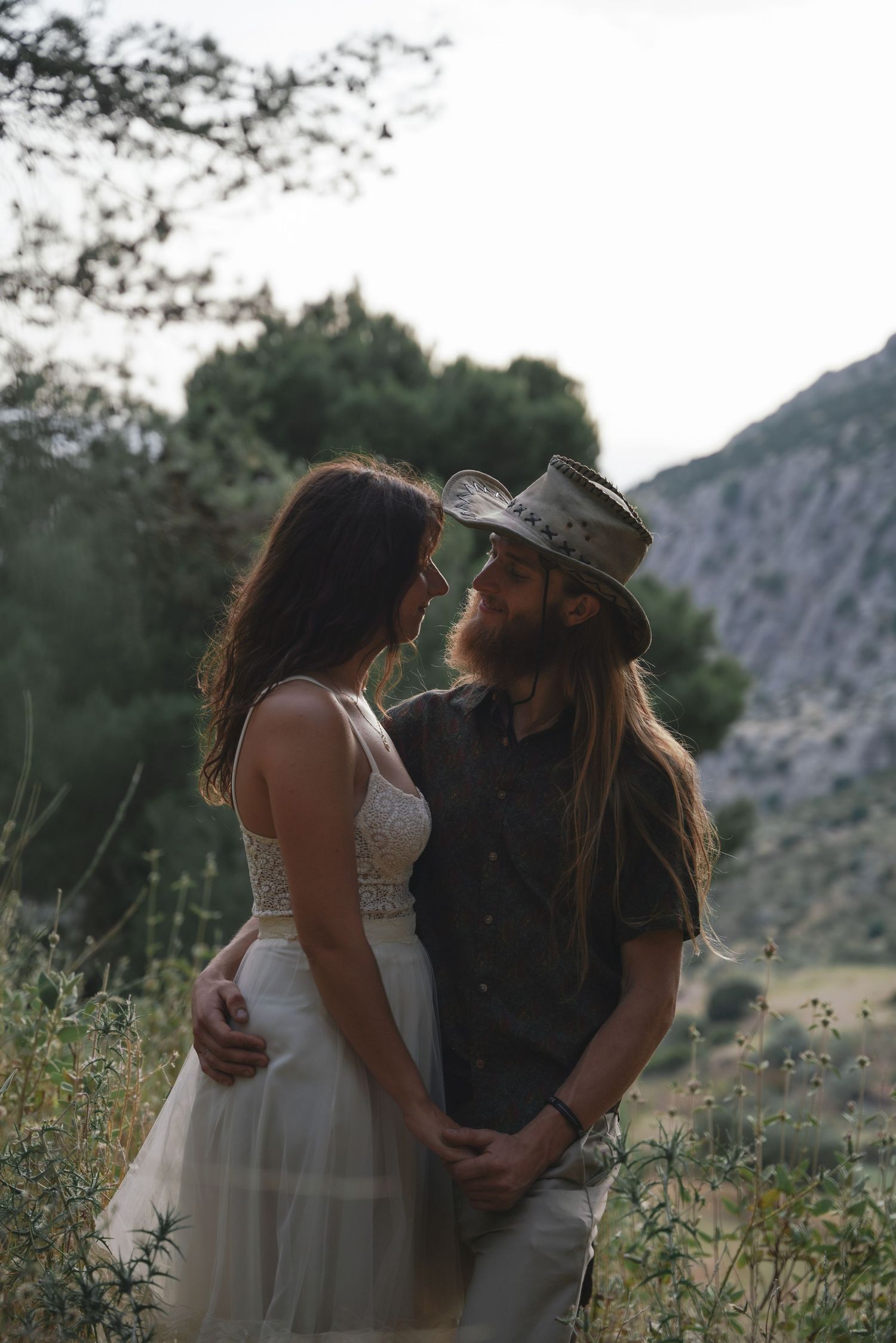 Intimate wedding moment captured between couple in rustic mountain setting.