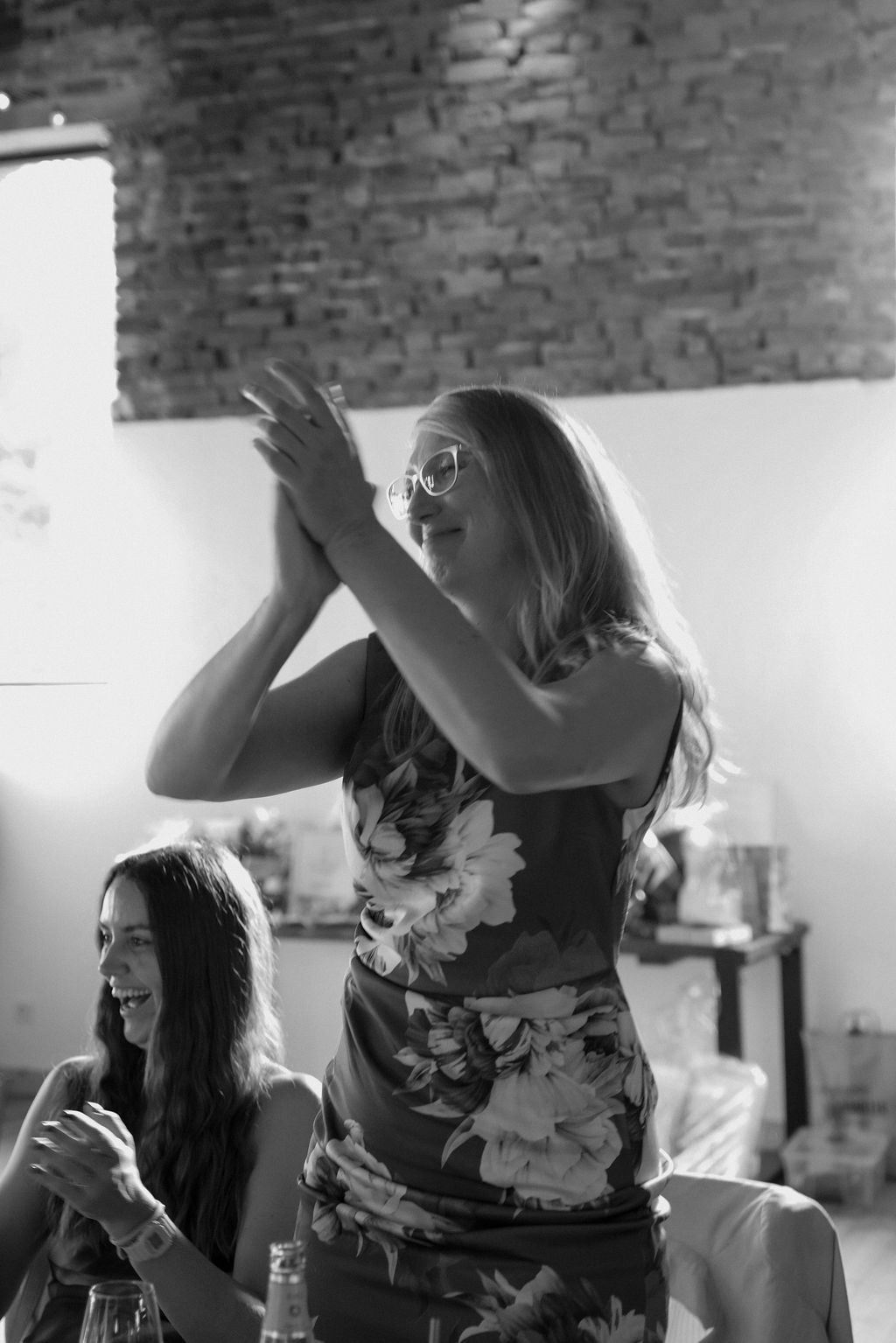 Black and white photo series showing dancers in expressive movement against a brick wall background.