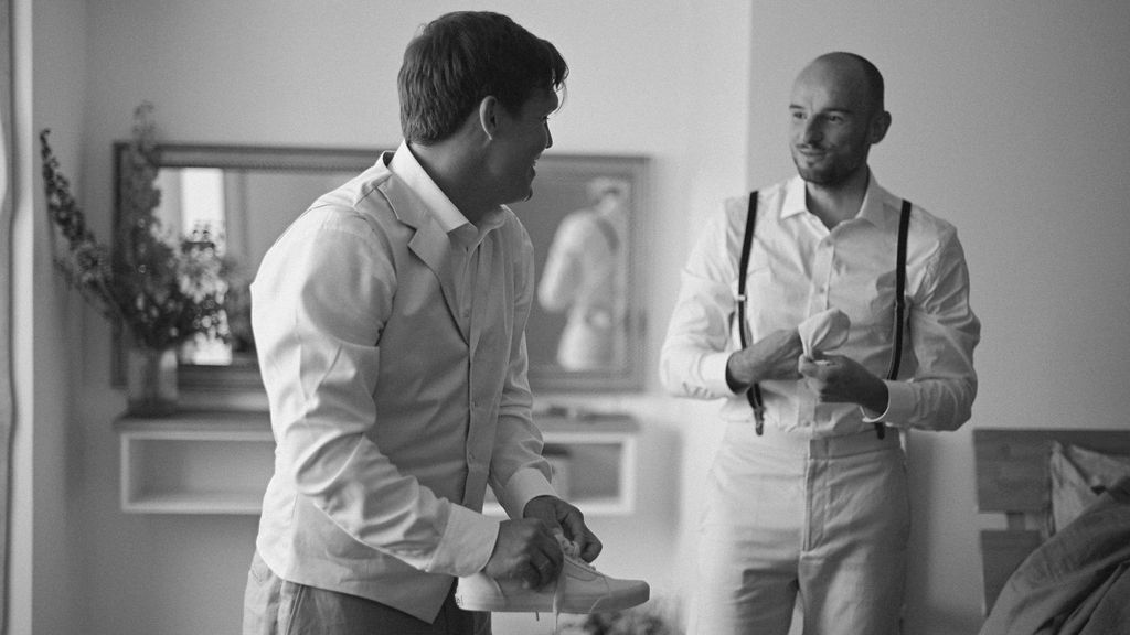 Medical professionals in white coats gather in a clinical setting for a consultation or meeting.