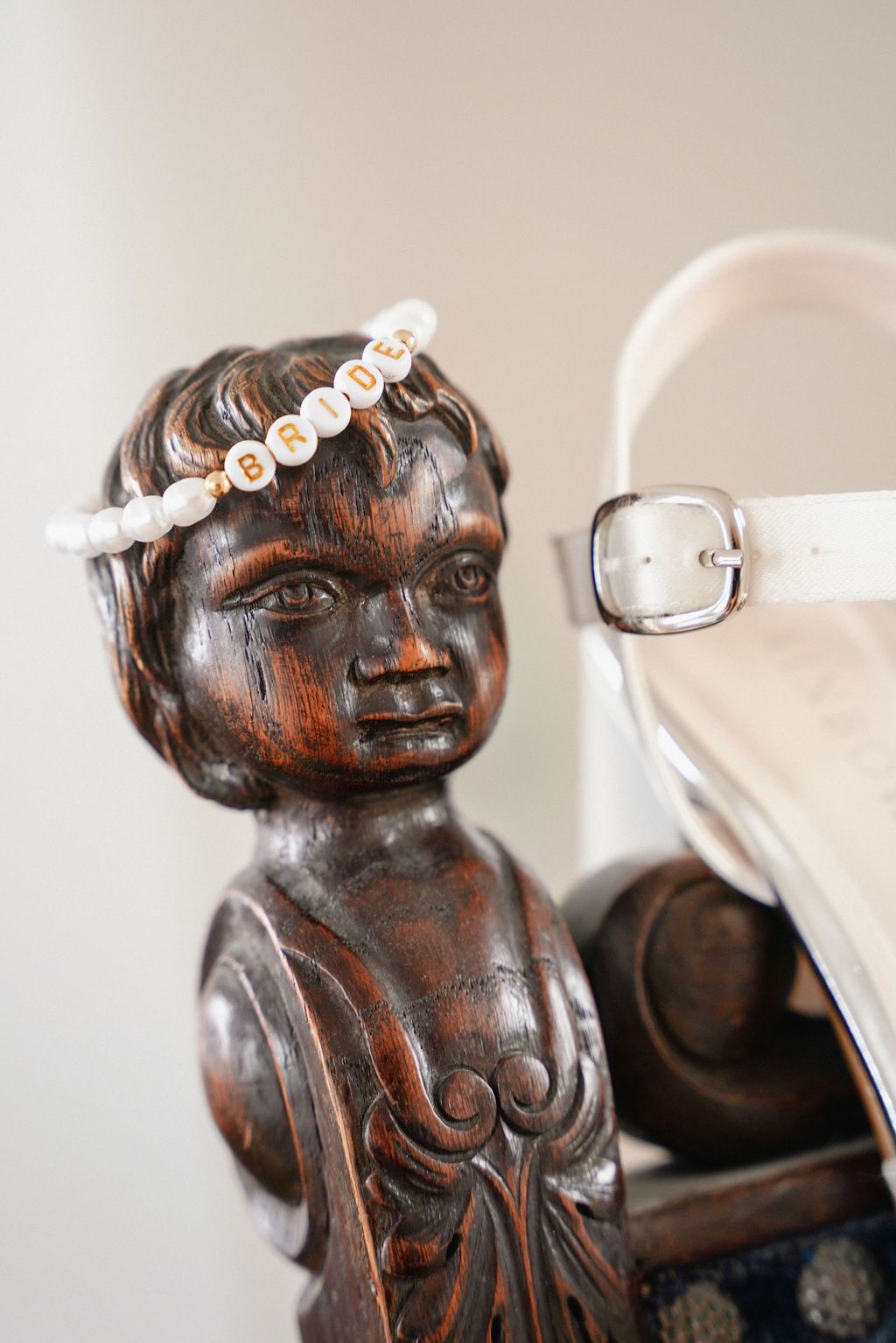 Detailed closeup shots of a dark wooden carved figurine with decorative elements shown from multiple angles.