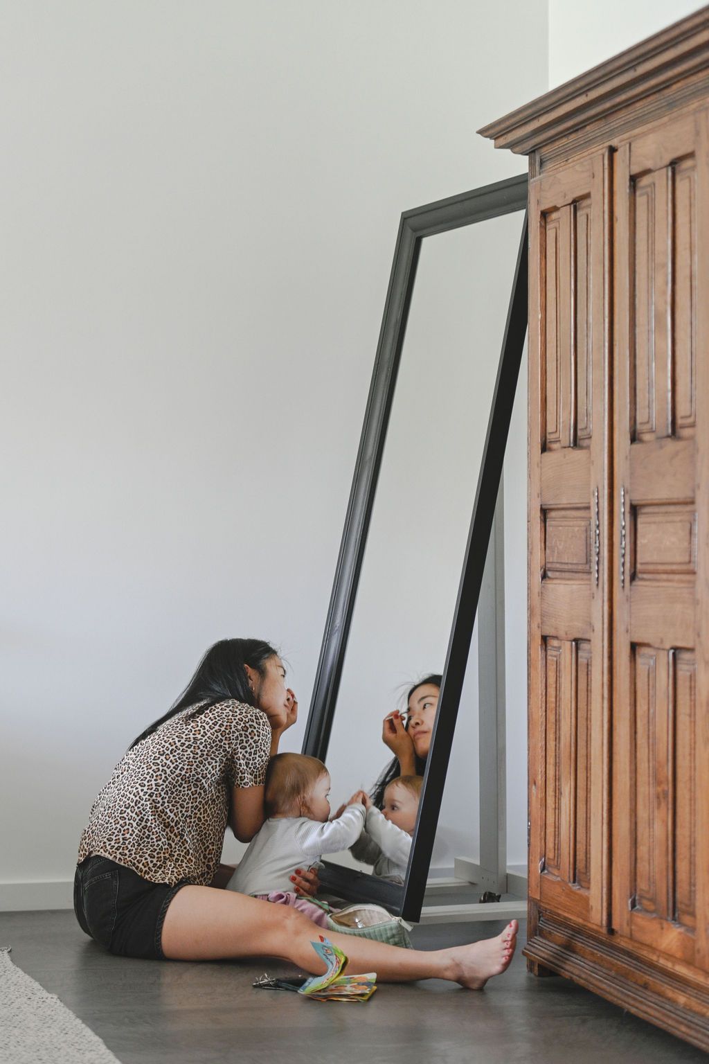 A series of photos showing someone looking under a door from different angles on a wooden floor.