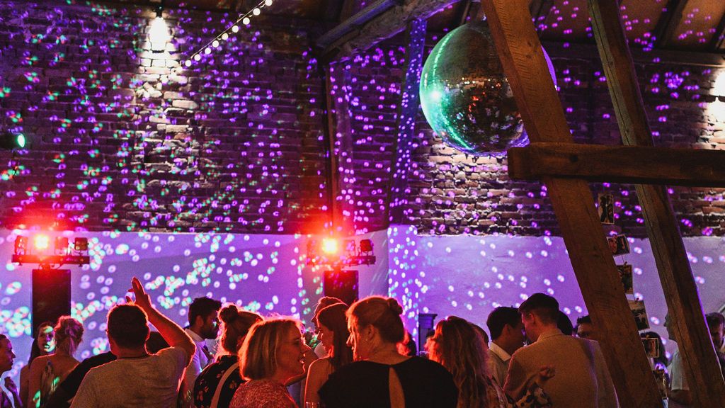 A concert venue ceiling adorned with purple string lights and illuminated decorations creates a magical atmosphere.