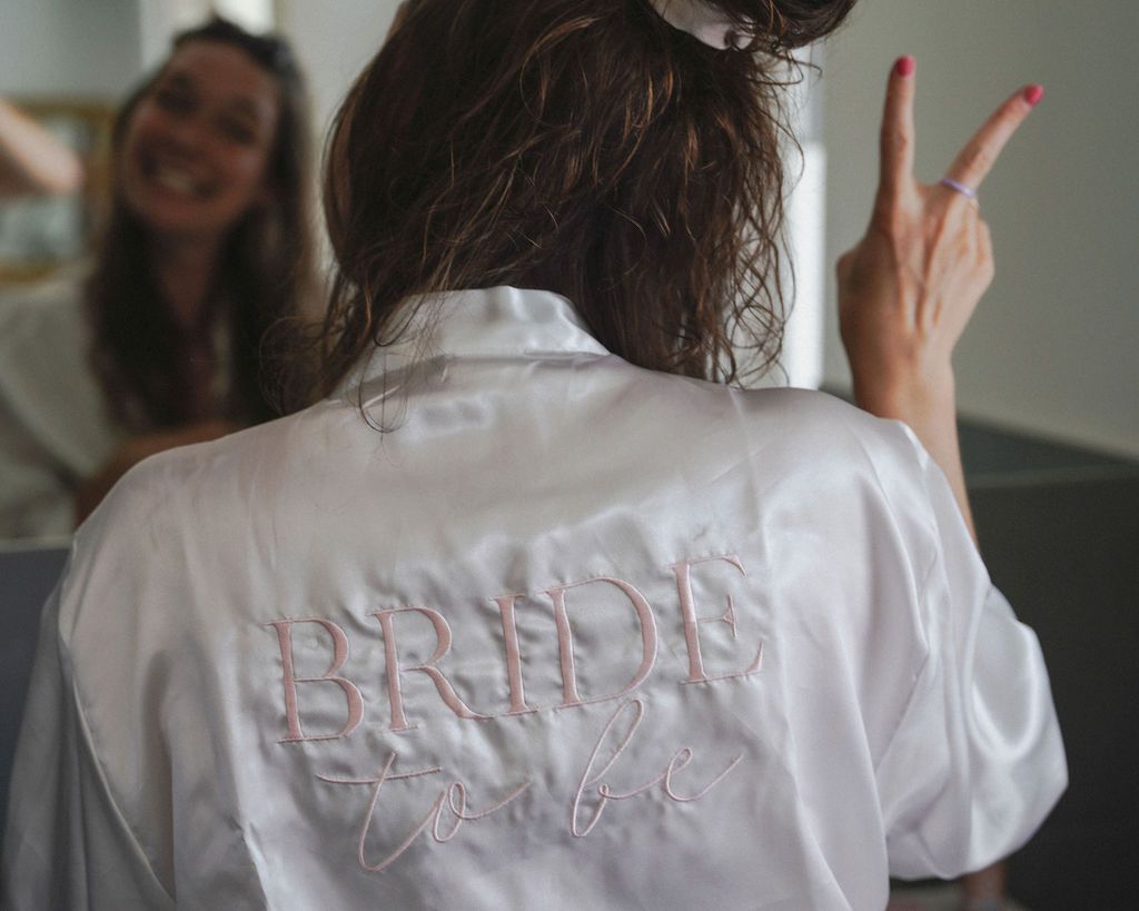 A series of back views showing embroidered text on a white button-down shirt.