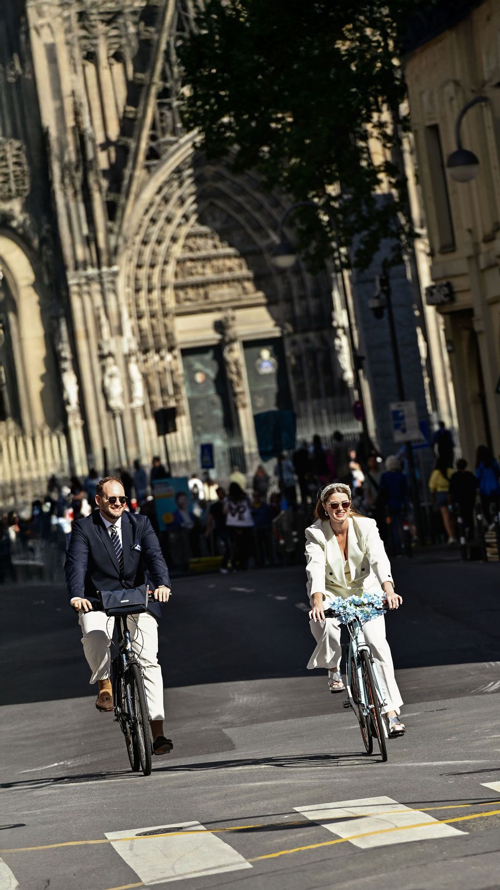 A sequence showing a cyclist riding through a historic European street with Gothic architecture.