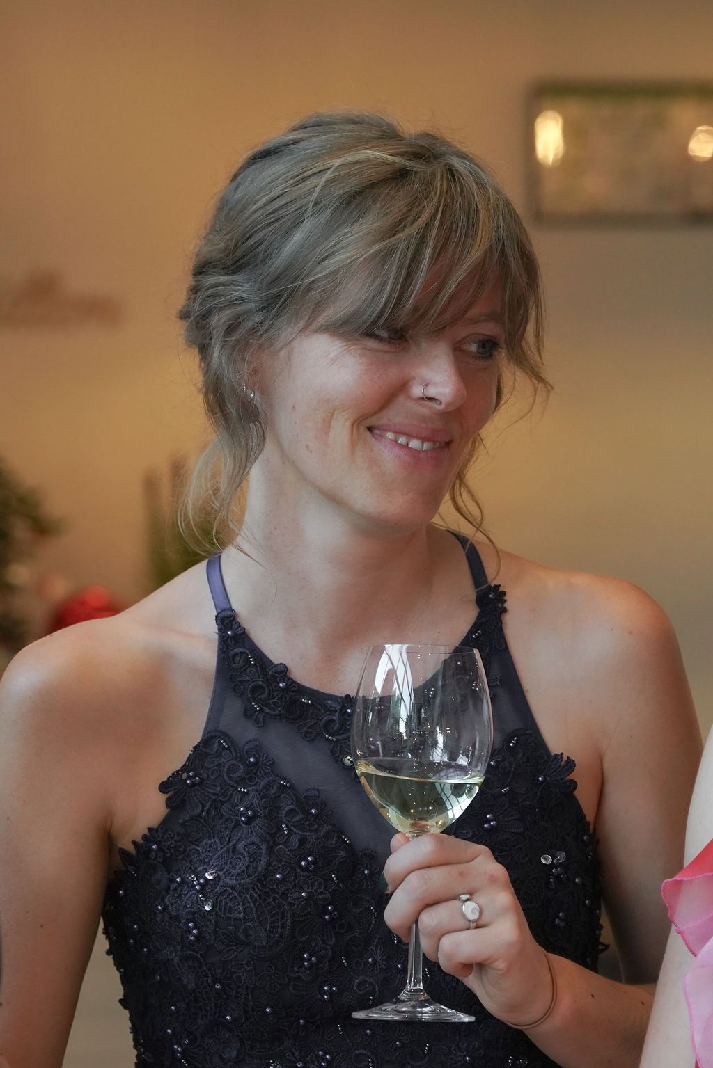 A sequence of photos shows someone in a black sequined dress holding and sipping from a wine glass.