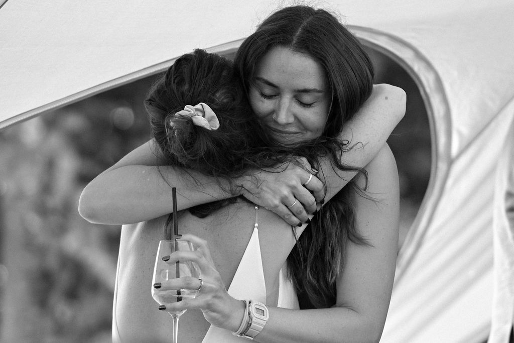 A series of intimate black and white photos showing tender romantic moments between a couple on white bedding.