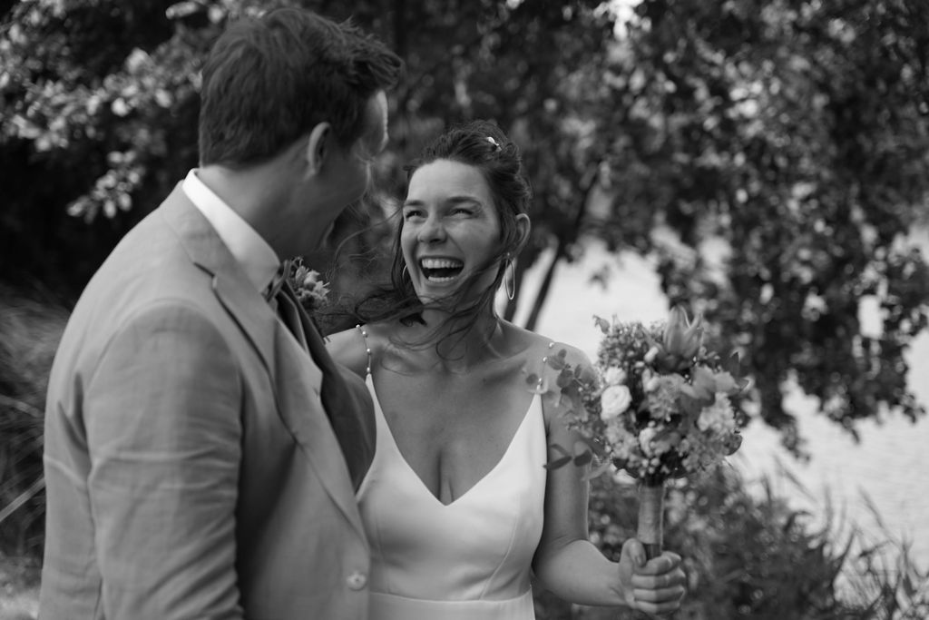 A collection of black and white wedding photos showing romantic moments between couples in outdoor garden settings.