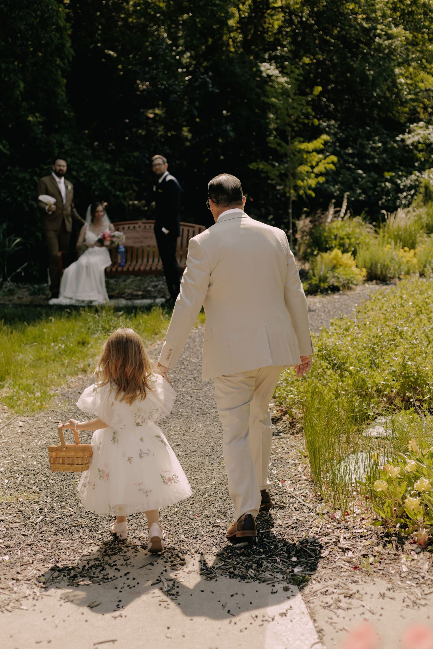 Wedding couple walking together through a wildflower meadow.