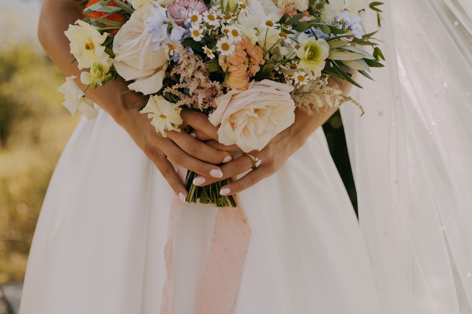Elegant bridal bouquet featuring pink and white roses with mixed flowers.