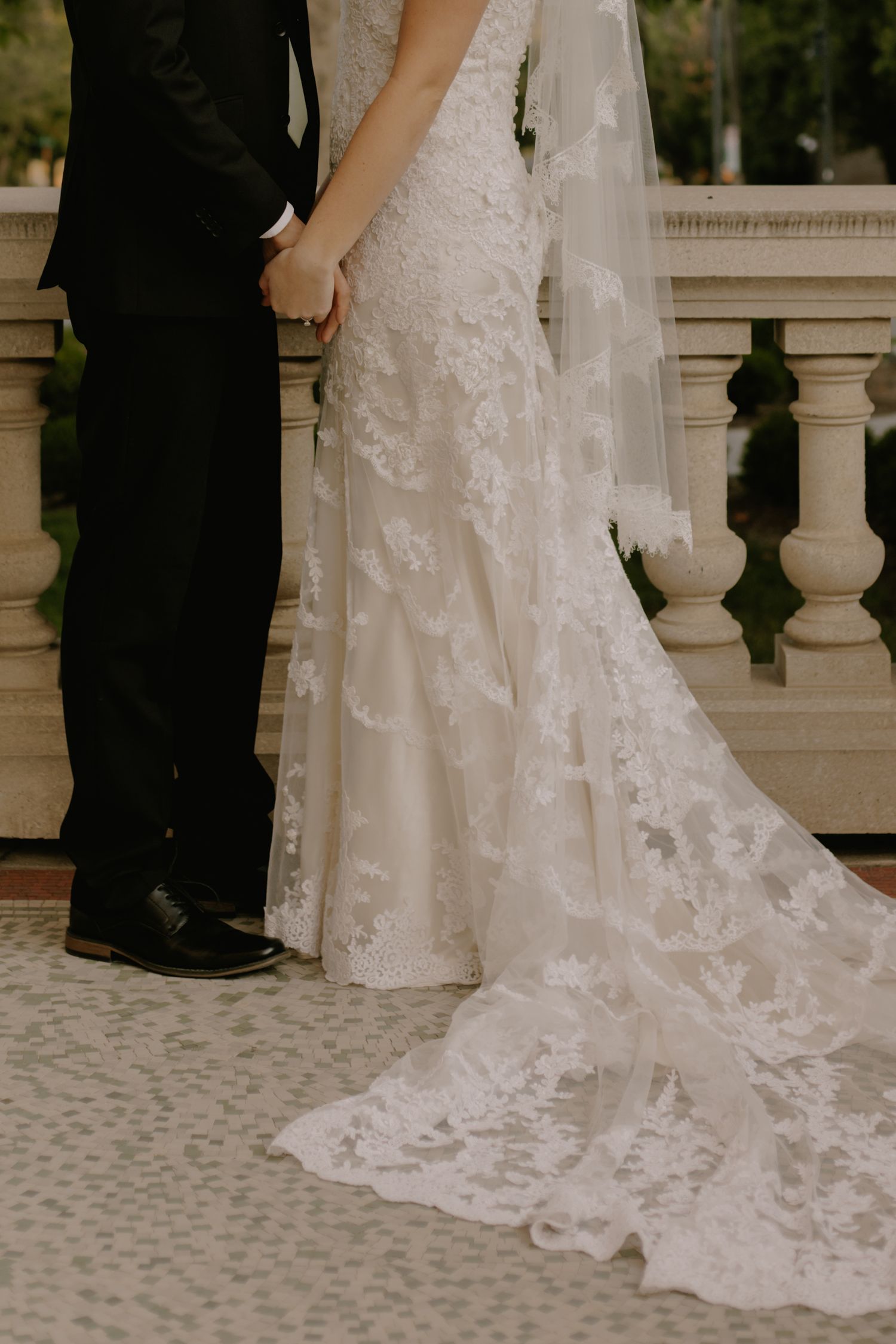 Close-up details of an intricate lace wedding dress train.