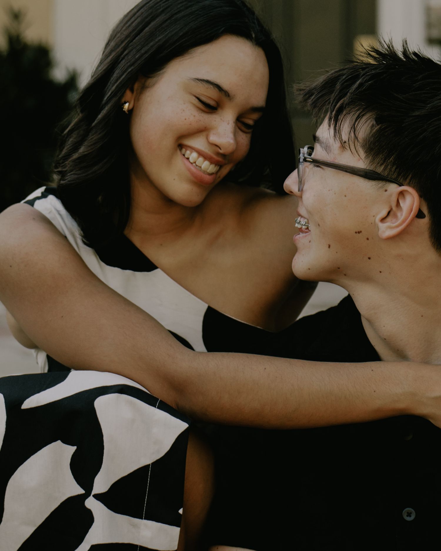 Intimate black and white portrait of couple sharing joyful moments together.