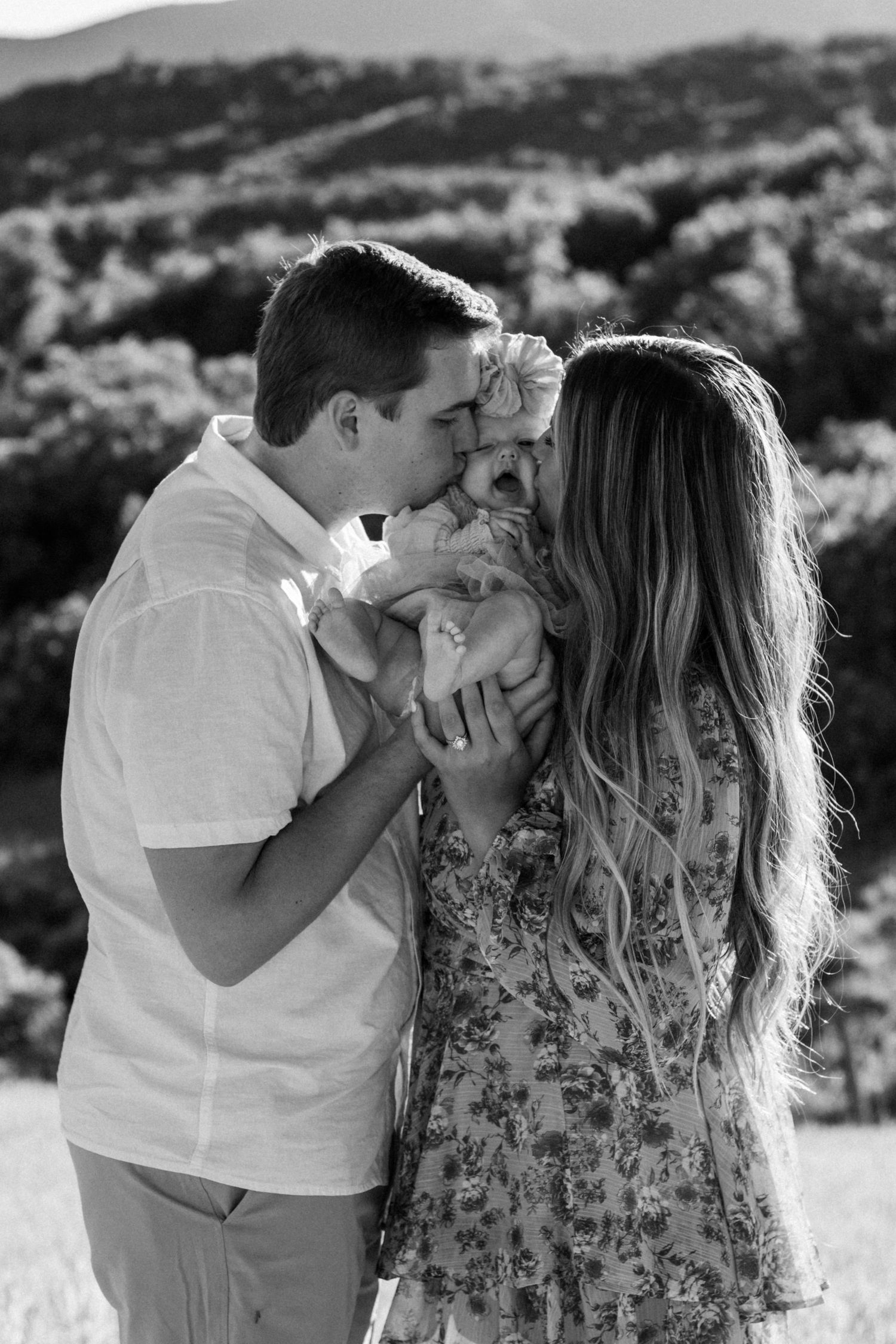 Black and white romantic photo sequence captured against a mountain landscape.