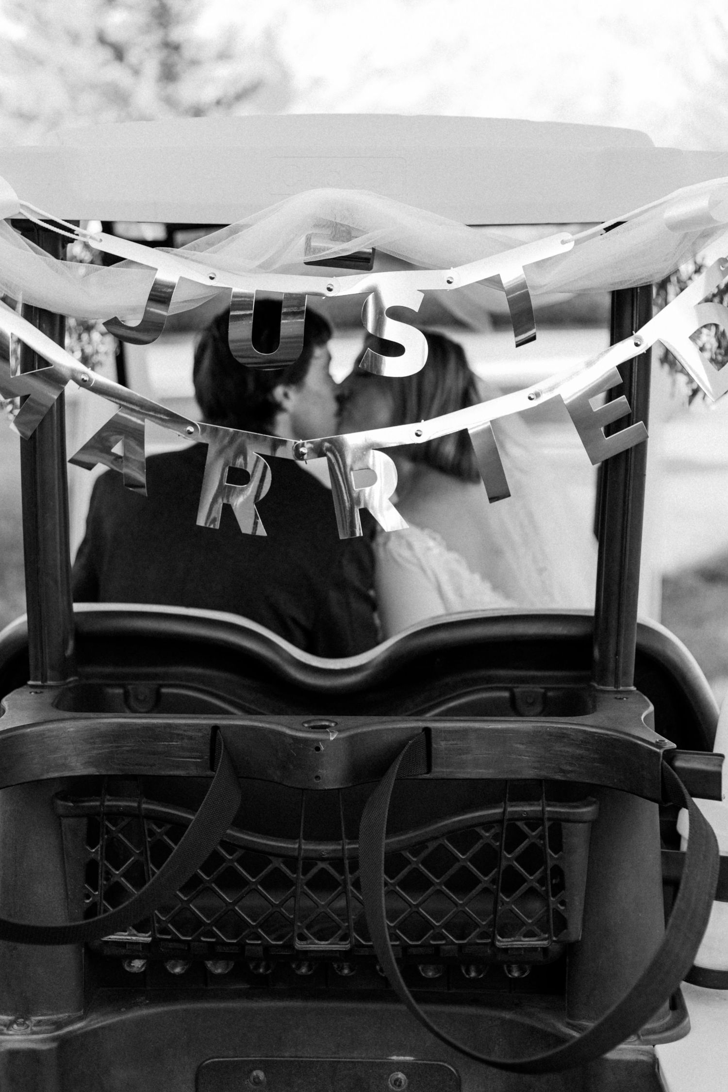Black and white detail shot of decorative banner or bunting hanging overhead.