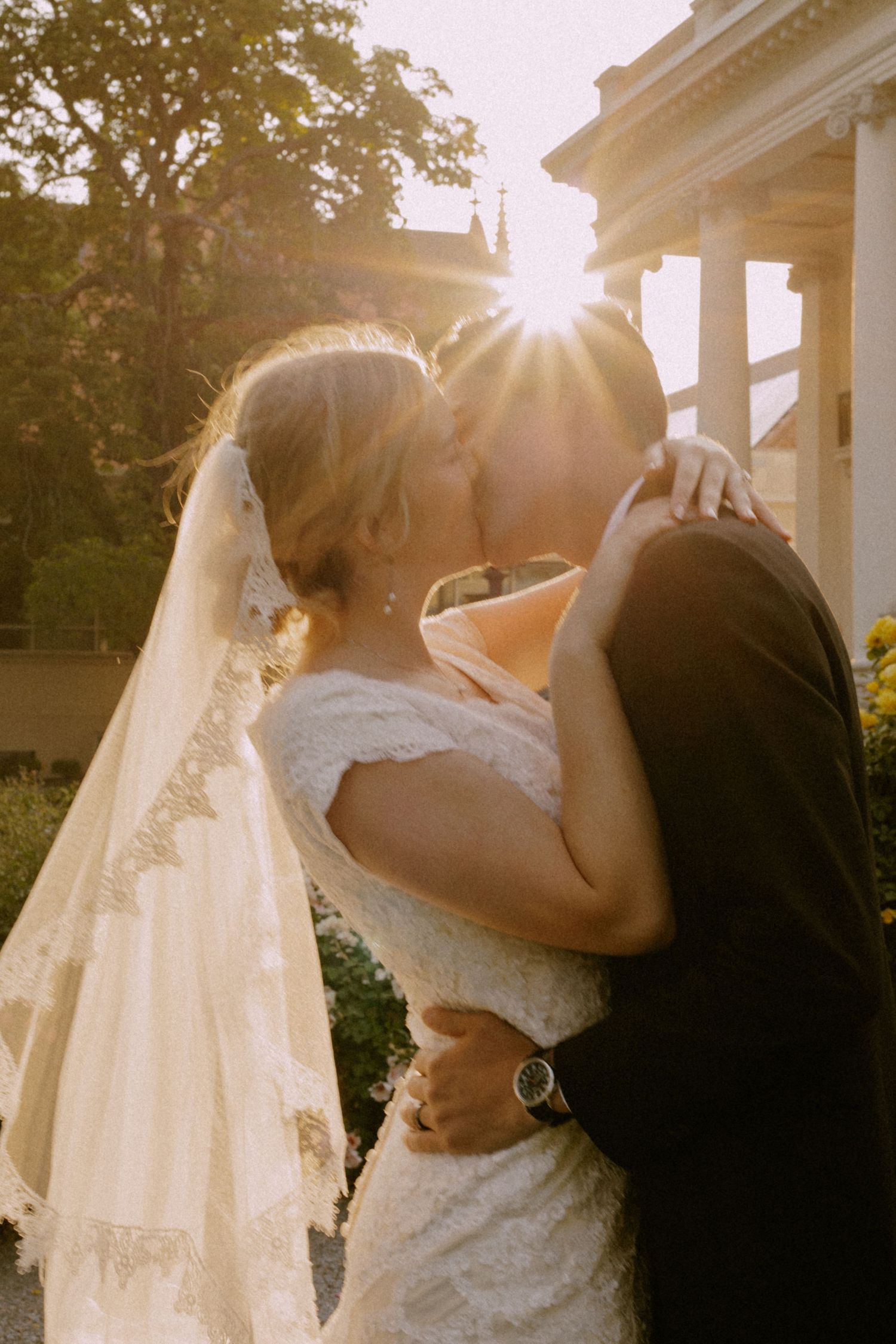 Romantic sunset wedding moment with flowing veil.