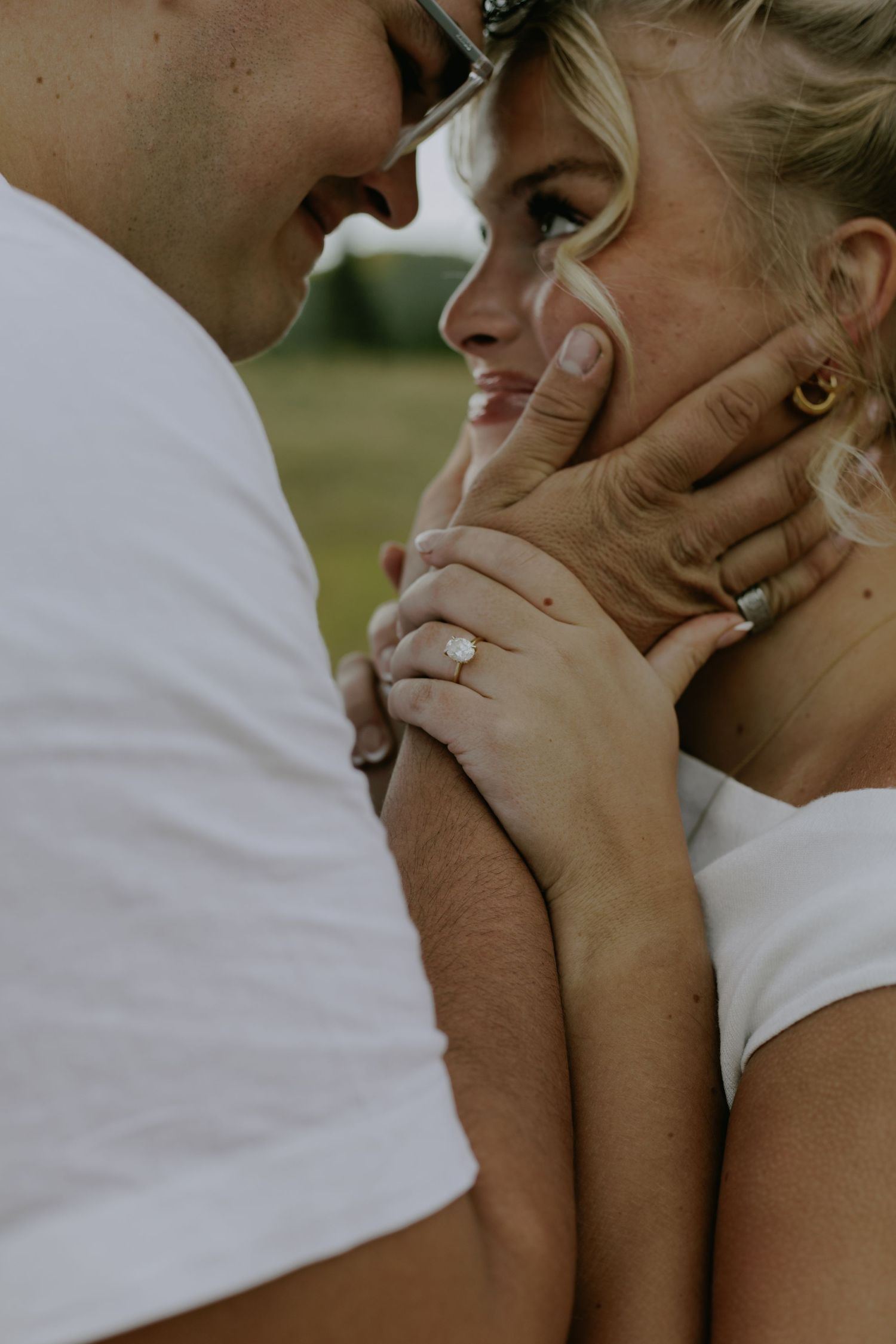 Close-up shot of two people sharing an intimate moment outdoors.