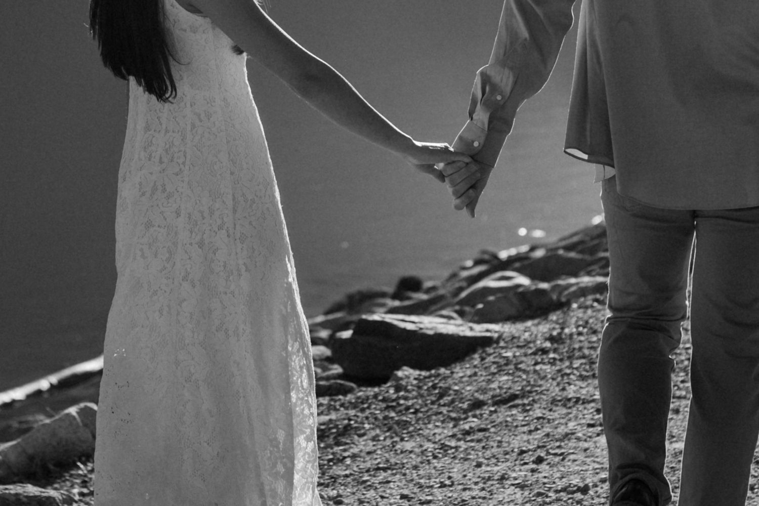 Silhouettes of formal attire against a bright outdoor backdrop.
