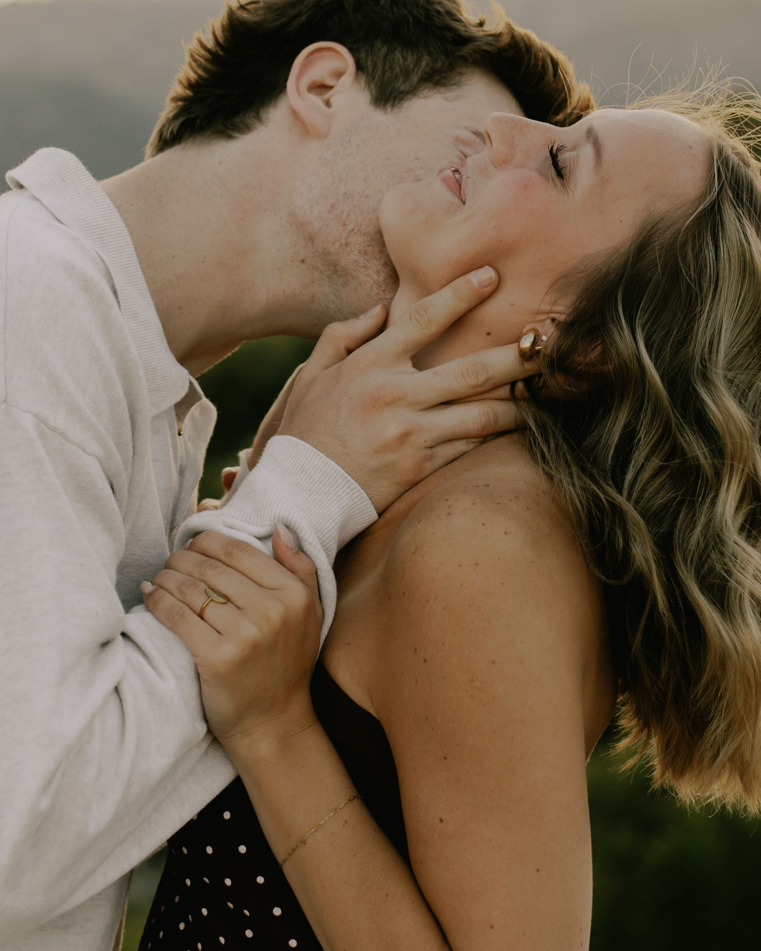 An intimate close-up moment between two people in warm lighting.
