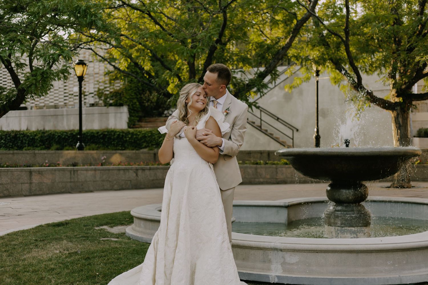Wedding photo series showing couple against backdrop of trees and fountain.