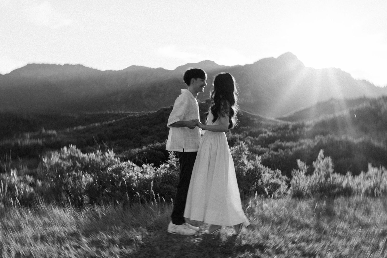 Scenic mountain landscape with dramatic sunset lighting and long shadows.